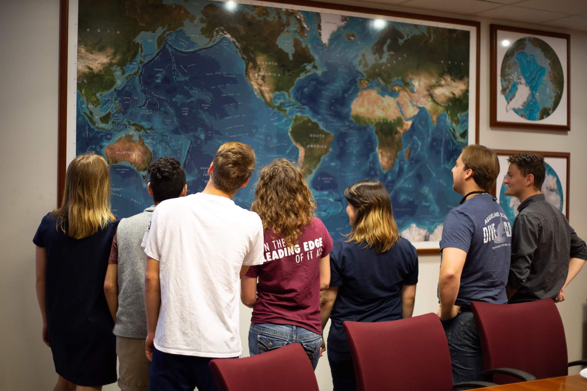 students looking at wall map